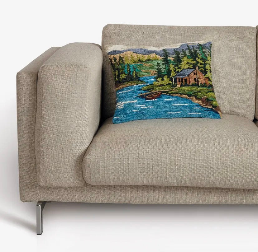 Hooked wool cushion featuring a lake and boathouse